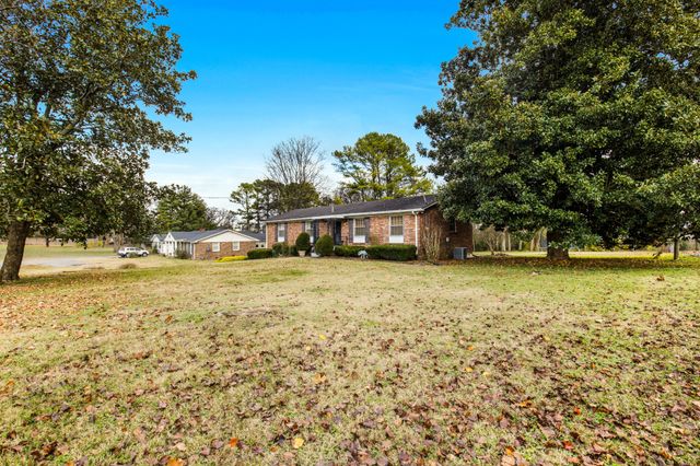 a front view of a building with a garden