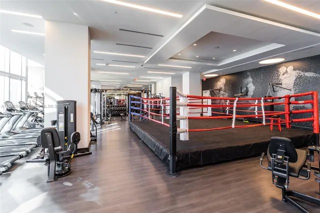 a view of a room with lots of gym equipment