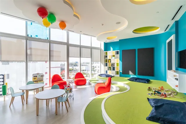 a view of a dining room with furniture and a floor to ceiling window