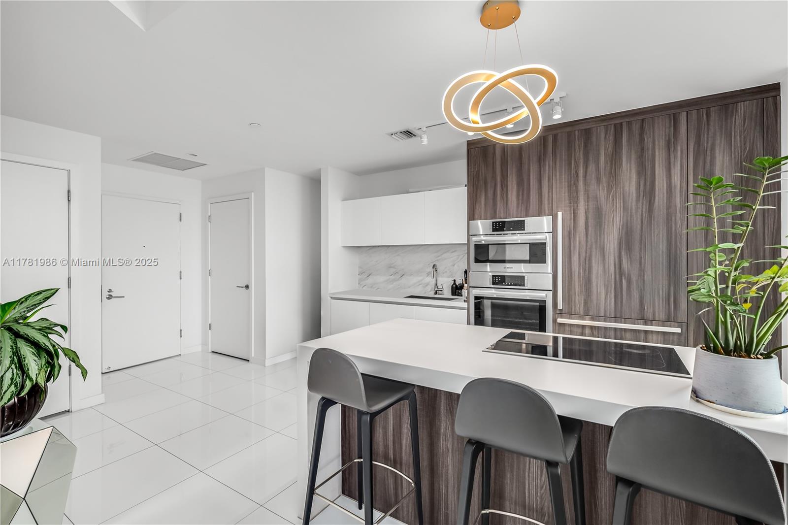 851 Northeast 1st Avenue, Unit 1102 Miami, FL 33132 - Photo 3 of 29 a kitchen with a table and chairs in it