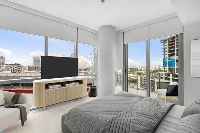 a bedroom with a bed and a television