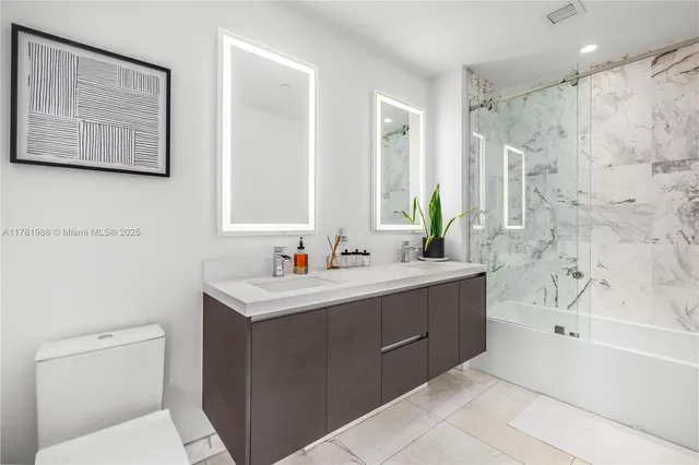 a bathroom with a bathtub sink mirror and toilet