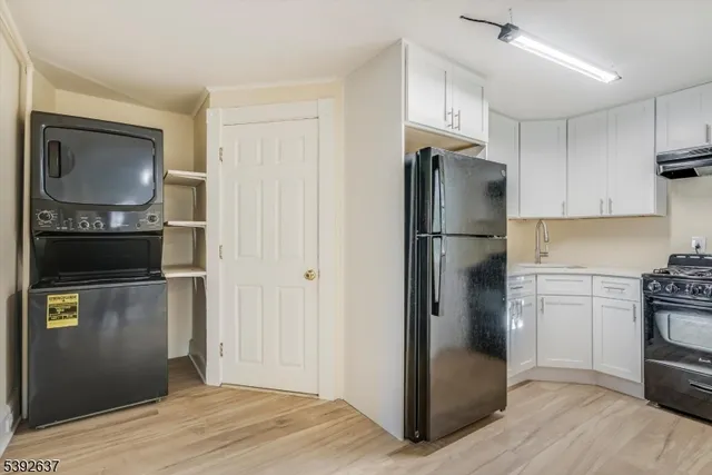 a kitchen with a refrigerator cabinet and a sink