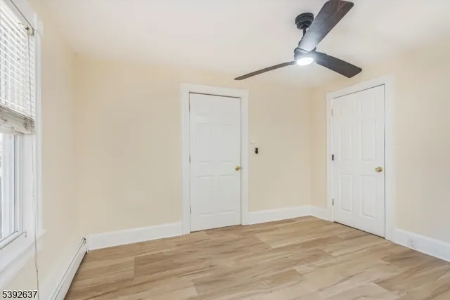 a view of a livingroom with a dishwasher and wooden floor