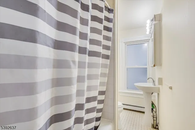 a bathroom with a black and white checkered floor