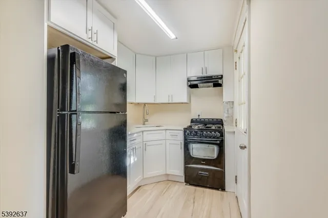 a kitchen with a refrigerator and a stove