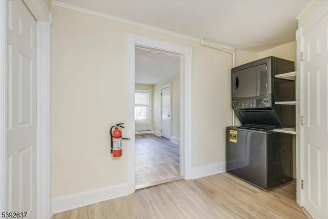 a view of hallway with wooden floor