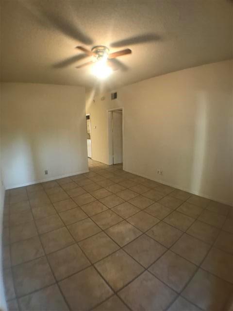 2216 San Gabriel Street, Unit 108 Austin, TX 78705 - Photo 5 of 9 Spare room featuring light tile patterned flooring, a textured ceiling, ceiling fan, and visible vents