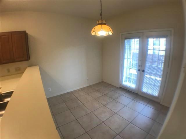 2216 San Gabriel Street, Unit 108 Austin, TX 78705 - Photo 7 of 9 Unfurnished dining area featuring light tile patterned flooring and french doors