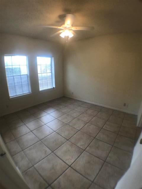 2216 San Gabriel Street, Unit 108 Austin, TX 78705 - Photo 8 of 9 Unfurnished room with light tile patterned floors and ceiling fan