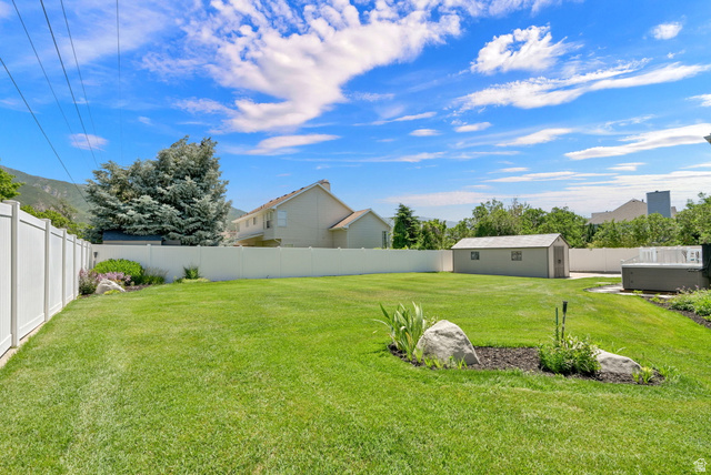 4792 Glasmann Way South Ogden, UT 84403 - Photo 24 of 70 Expansive green lawn framed by a white privacy fence