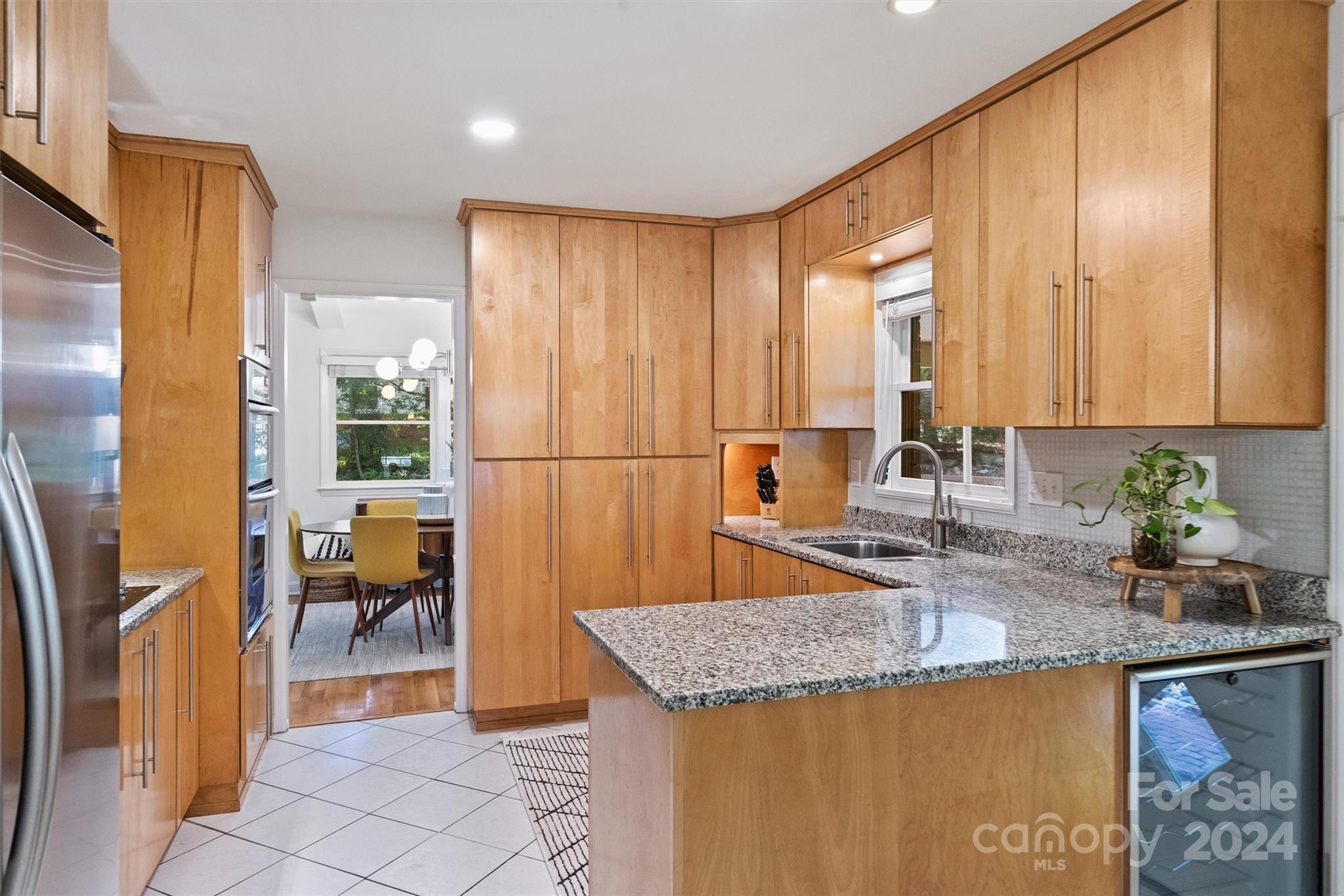 6810 Folger Drive Charlotte, NC 28270 - Photo 12 of 47 a kitchen with granite countertop a sink a stove and a refrigerator