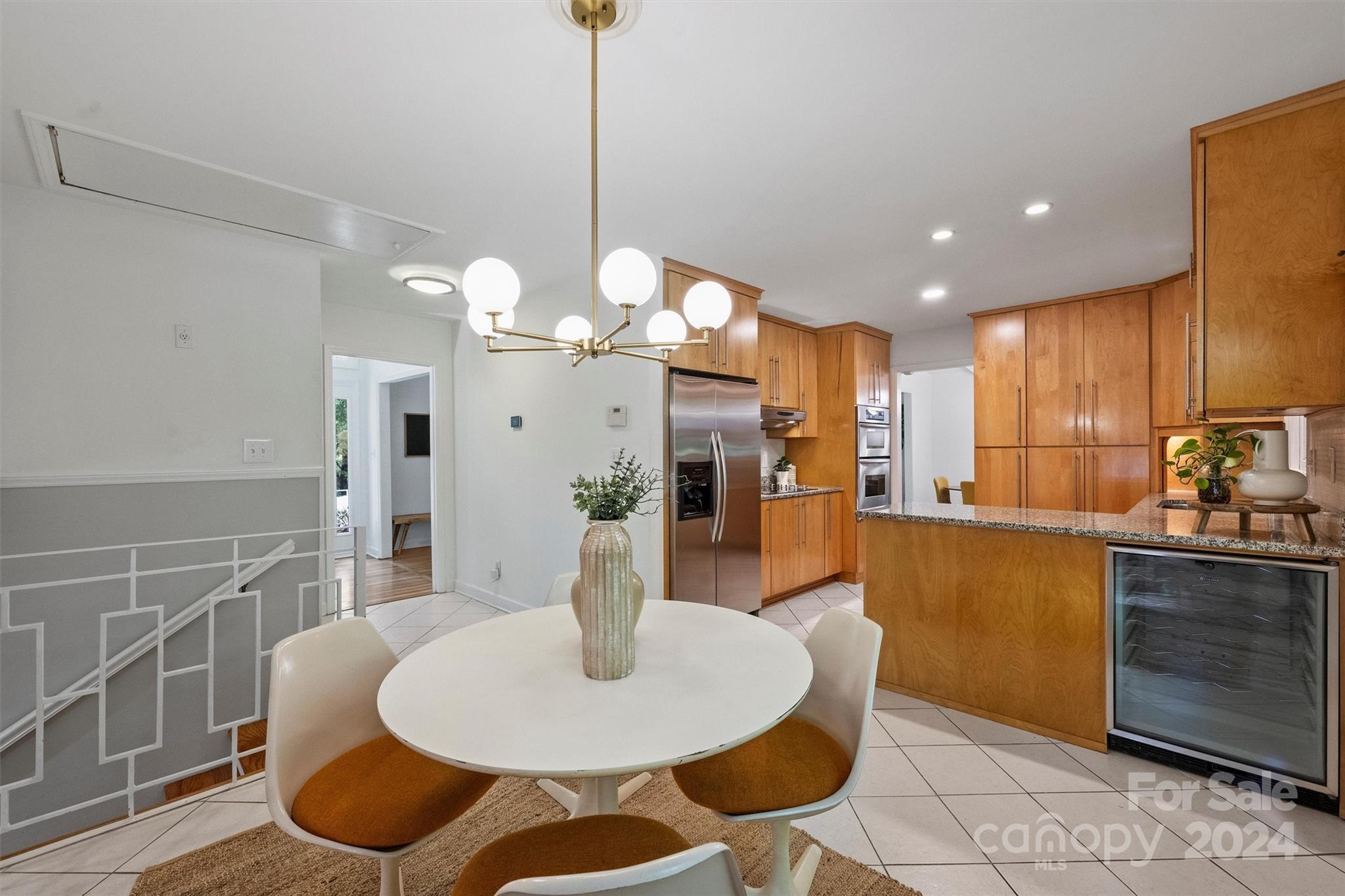 6810 Folger Drive Charlotte, NC 28270 - Photo 14 of 47 a kitchen with stainless steel appliances kitchen island granite countertop a table chairs and a refrigerator
