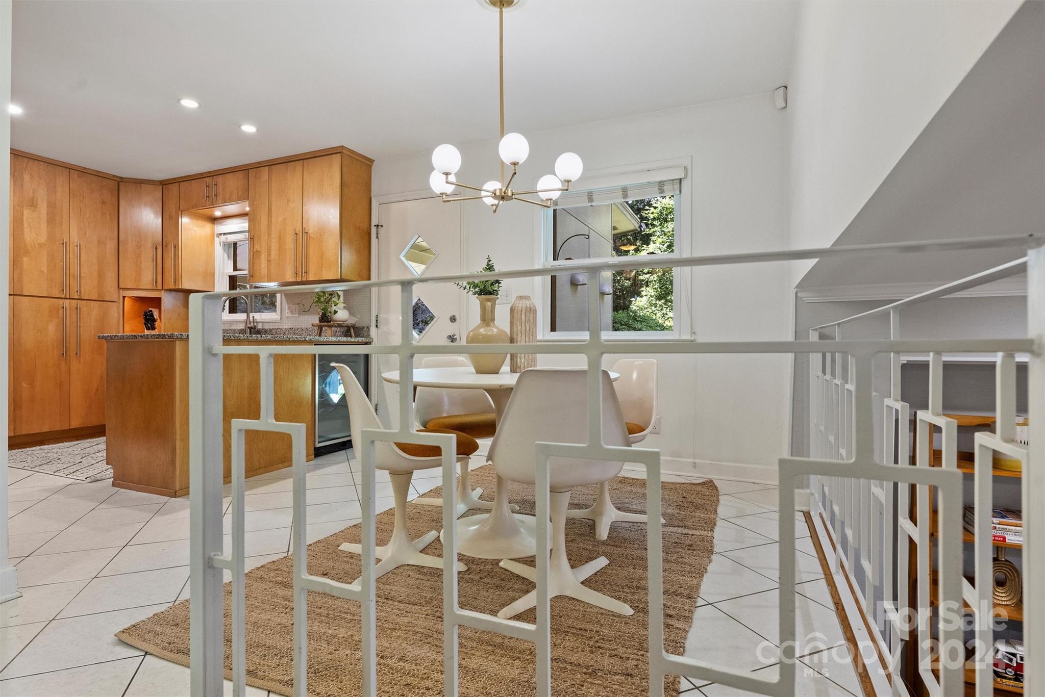 6810 Folger Drive Charlotte, NC 28270 - Photo 17 of 47 a view of a dining room with furniture a chandelier and wooden floor