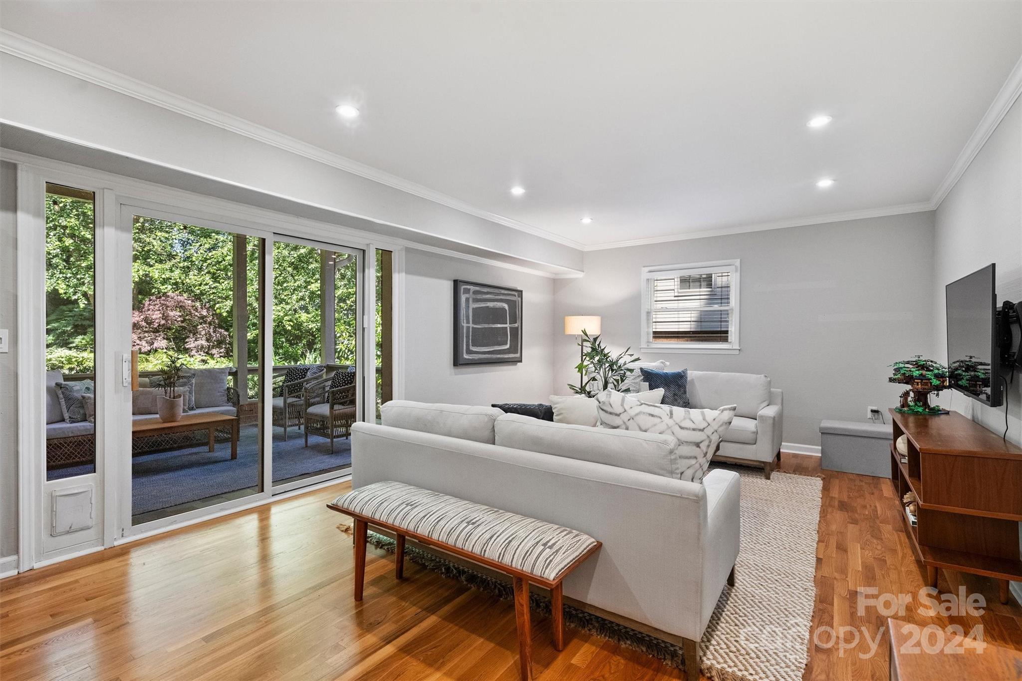 6810 Folger Drive Charlotte, NC 28270 - Photo 21 of 47 a living room with furniture a flat screen tv and a large window
