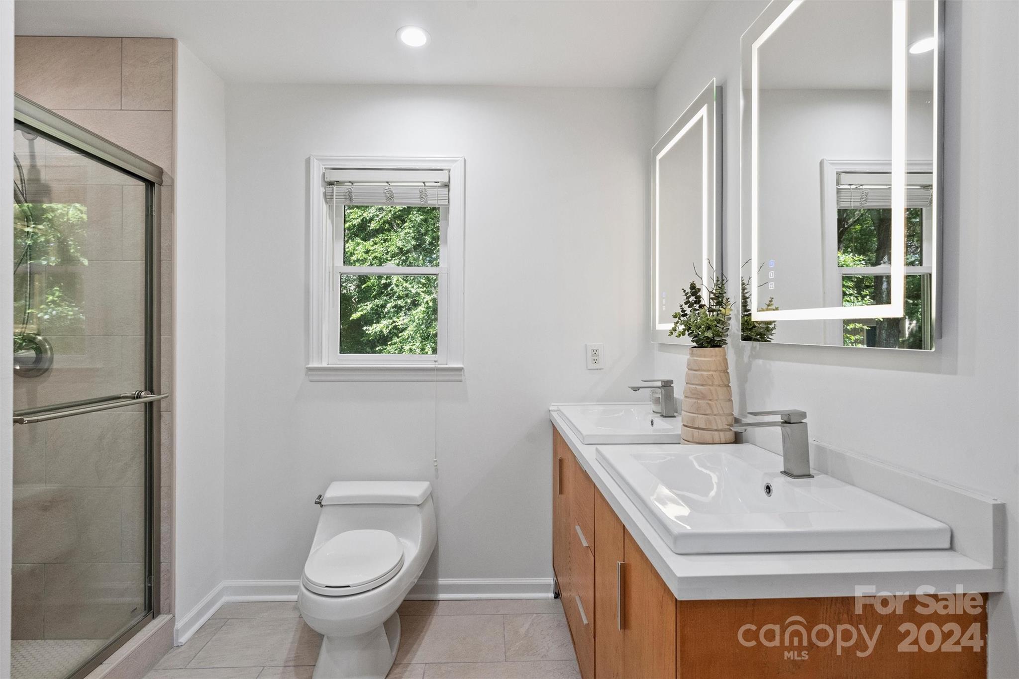 6810 Folger Drive Charlotte, NC 28270 - Photo 28 of 47 a bathroom with a sink toilet and mirror