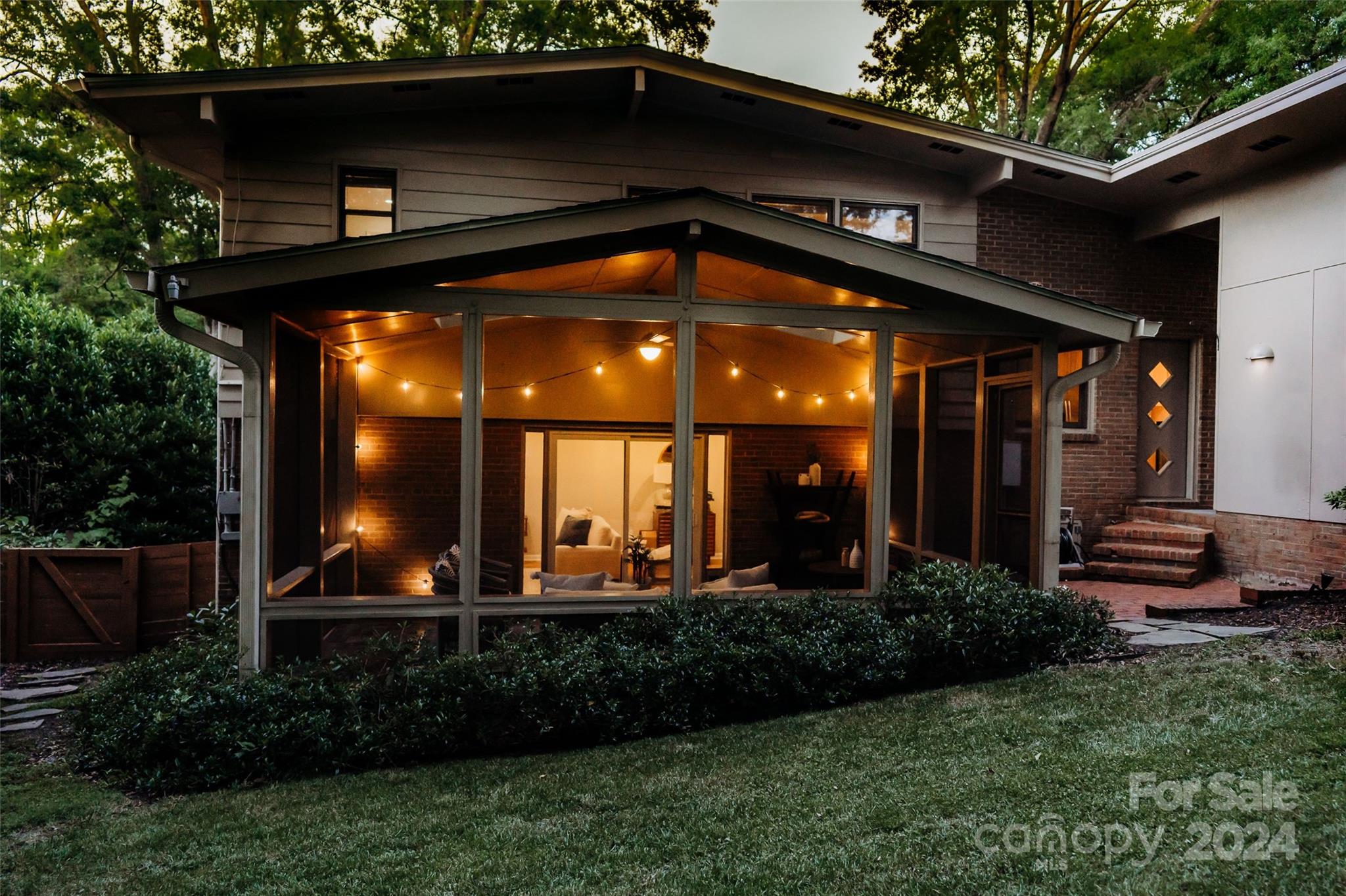 6810 Folger Drive Charlotte, NC 28270 - Photo 35 of 47 a view of a house with large windows and plants
