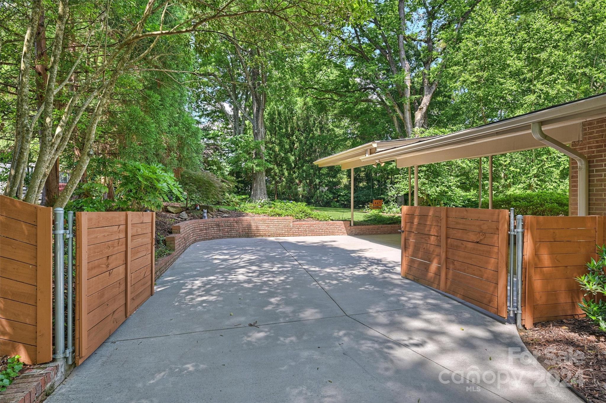 6810 Folger Drive Charlotte, NC 28270 - Photo 43 of 47 a view of a backyard with wooden fence