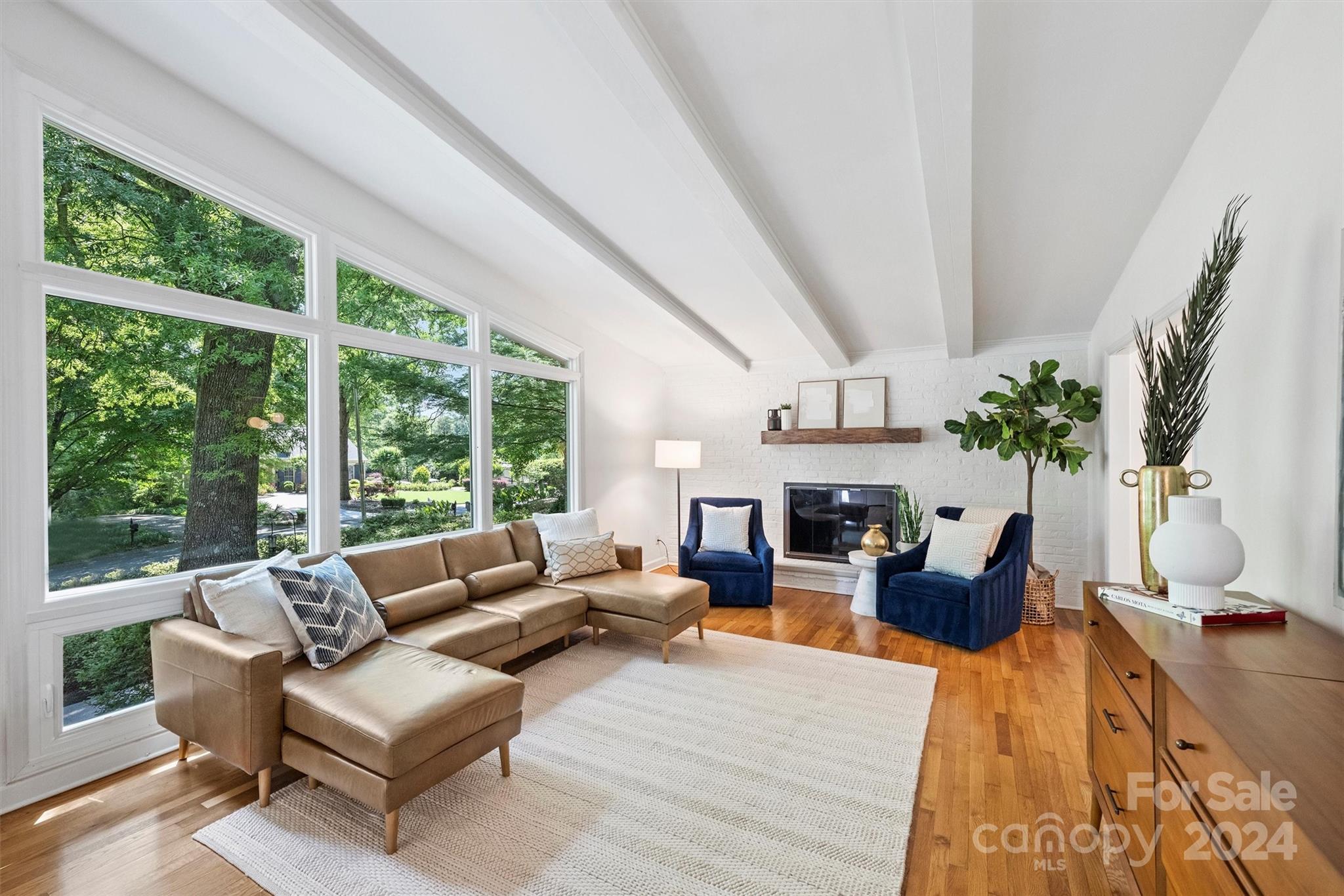 6810 Folger Drive Charlotte, NC 28270 - Photo 6 of 47 a living room with furniture fireplace and large windows
