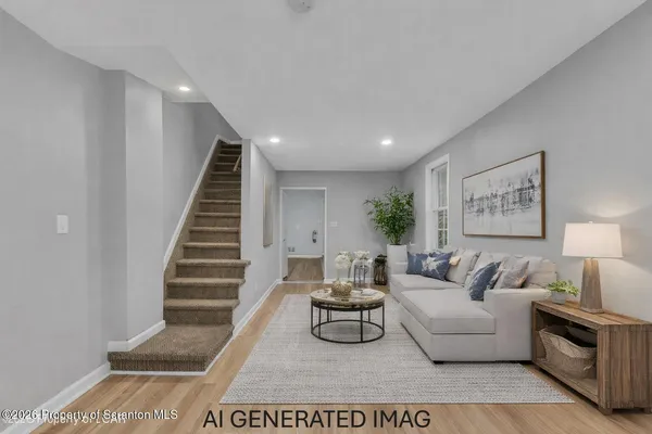a living room with furniture and a potted plant