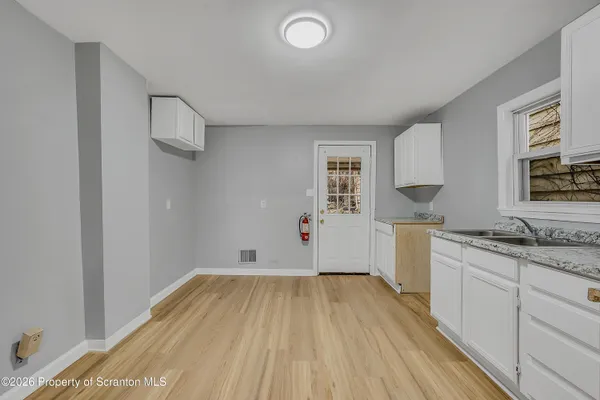 a room with a wooden floor and window