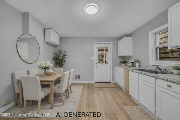 a kitchen with a dining table chairs and white cabinets