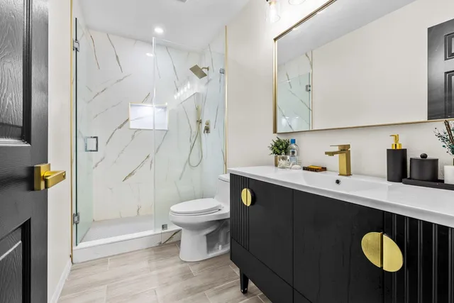 a bathroom with a sink toilet and shower