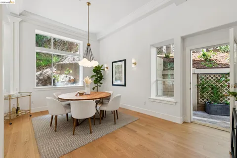 a dining room with furniture window and wooden floor