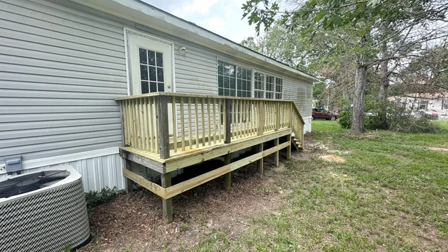 a view of a chairs and table in the back yard
