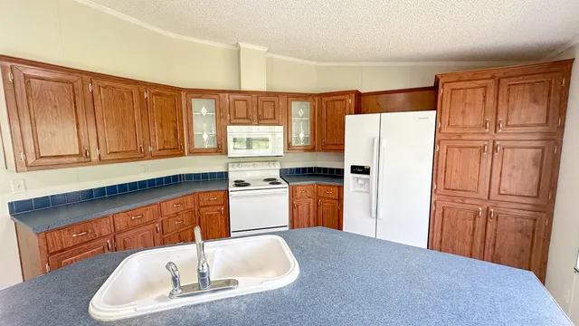 a kitchen with refrigerator cabinets and wooden floor