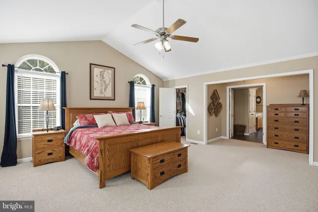 a spacious bedroom with a bed and a chandelier