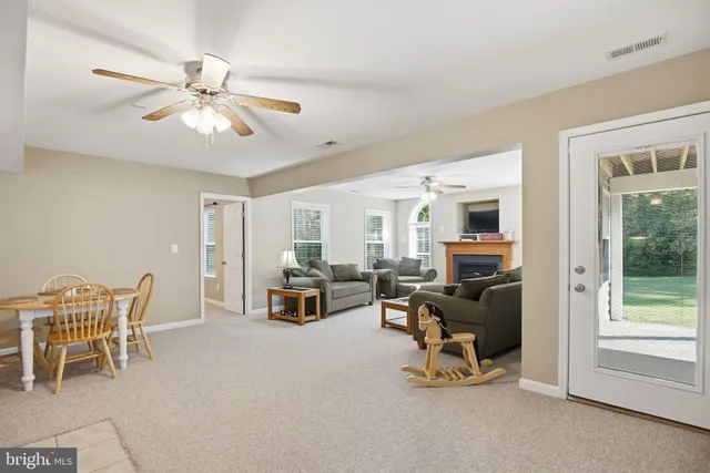 a view of a livingroom with workspace and a window