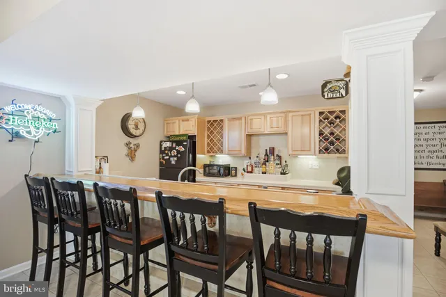 a view of a dining room and a kitchen with a table and chairs