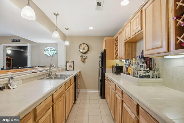 a kitchen with stainless steel appliances granite countertop a sink and cabinets
