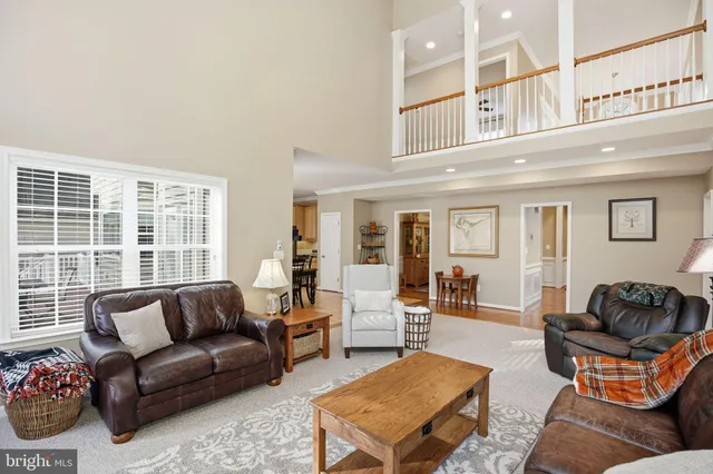a living room with furniture a rug and a large window