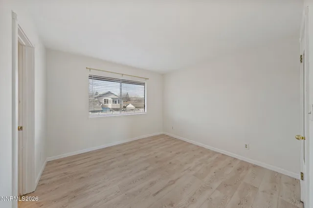 a view of a balcony with two couches and wooden fence