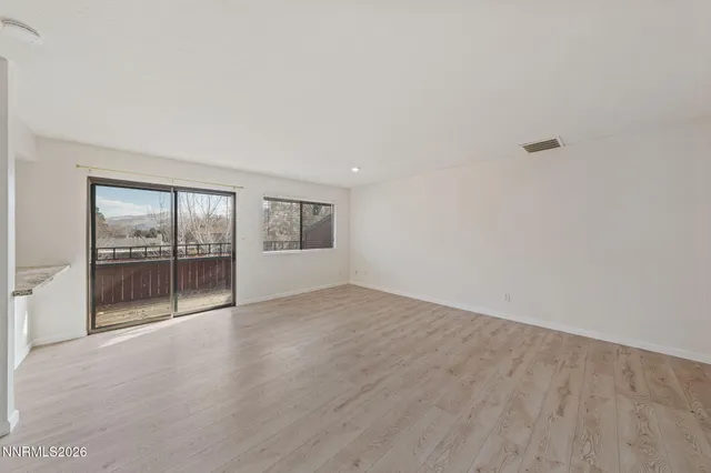 a view of a living room and a balcony