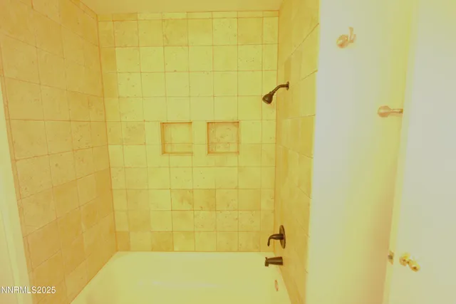 a bathroom with a tub sink and shower