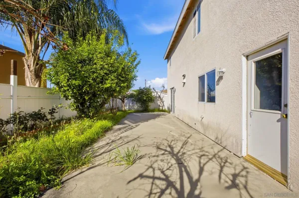 a pathway of a house with a yard