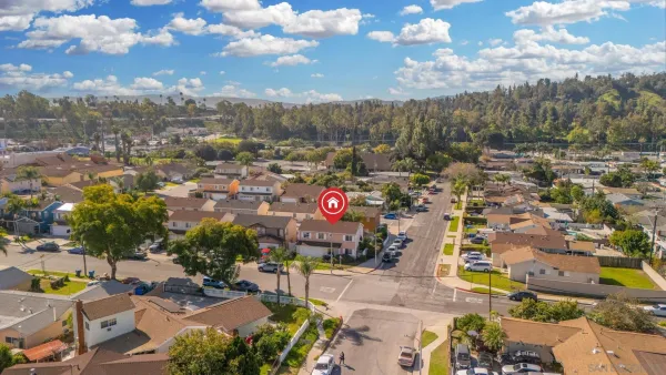 an aerial view of residential building with green space
