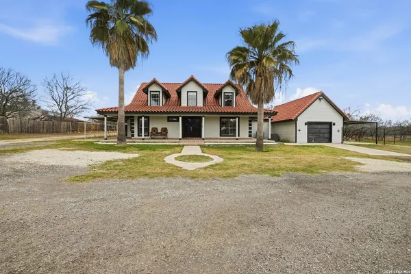 a view of a large house with a swimming pool and a yard