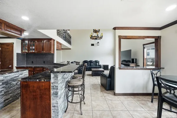 a kitchen with stainless steel appliances granite countertop a sink stove and cabinets