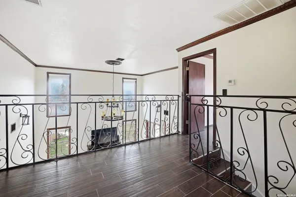 a bedroom with a bed wooden floor and window