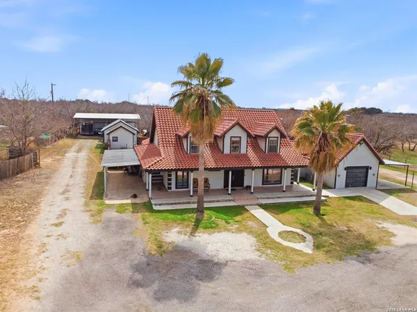 a view of a house with swimming pool and a yard