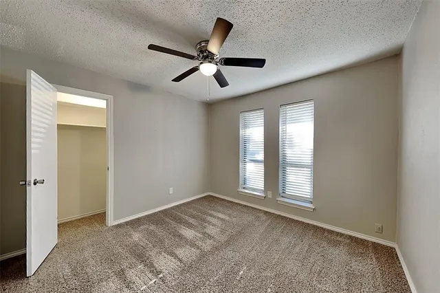 a view of empty room with ceiling fan