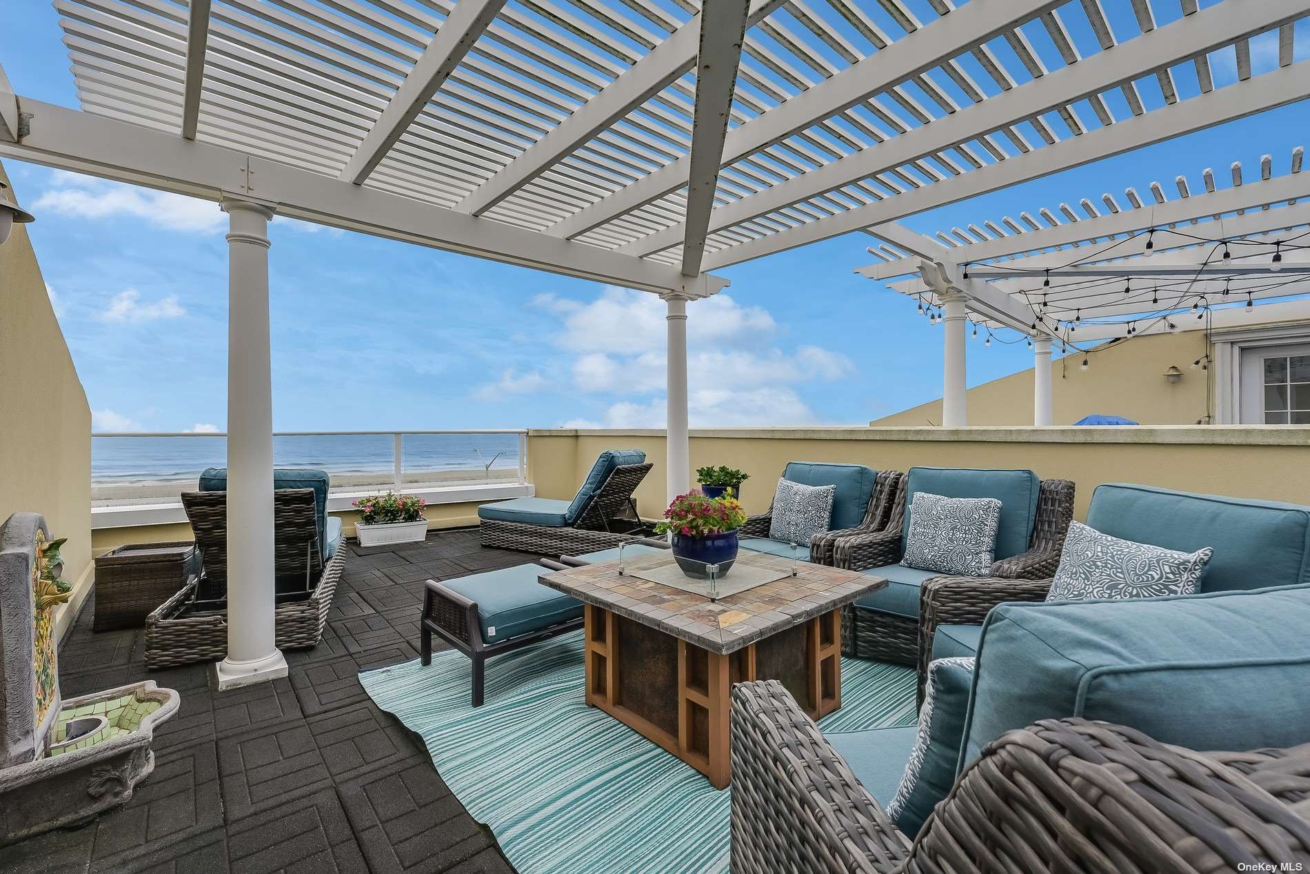 a roof deck with a table and chairs