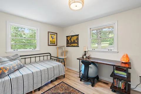 a bedroom with a bed and a window