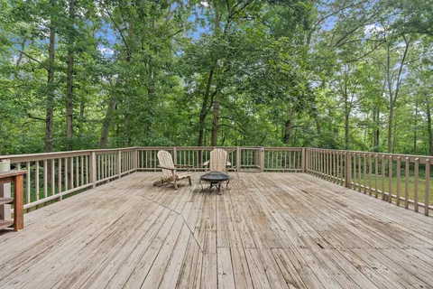 a view of a wooden deck with chairs