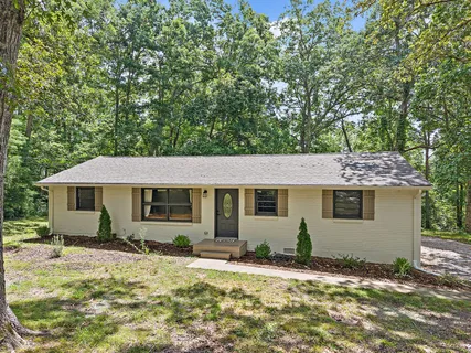 a backyard of a house with yard and outdoor seating