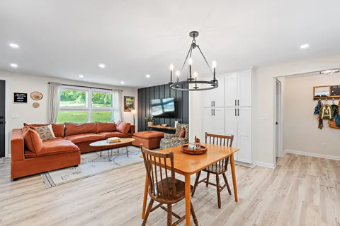 a living room with furniture dining table and a window